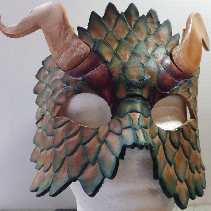 Hand carved scales highlight the mask